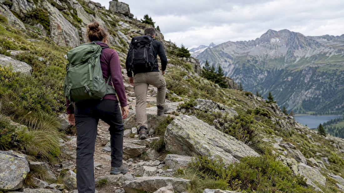 Deux marcheurs progressent sur un chemin caillouteux